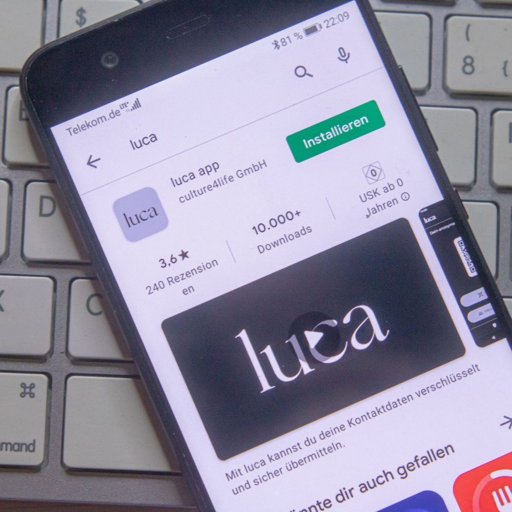 Neckargemuend, Germany: February 23, 2021: app icon of the a new german covid-app named luca on phone screen top view on keyboard, Illustrative Editorial.